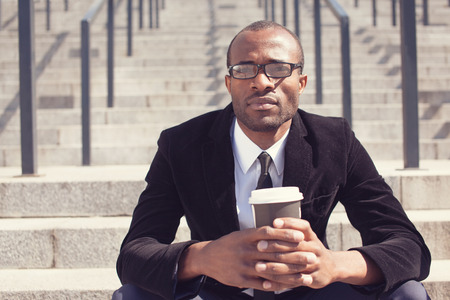 black bussinesman sitting with coffee during a lunchの写真素材
