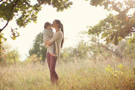 Mother and toddler walking outdoorsの写真素材