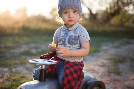 Toddler posing with toy race carの写真素材