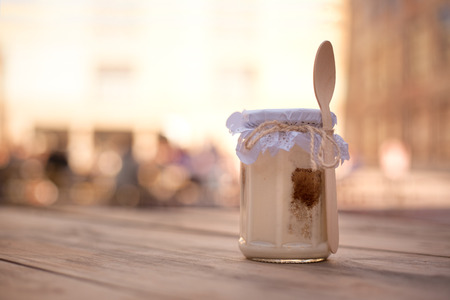 packed jar of tiramisu on wooden tableの写真素材