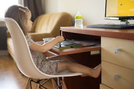 toddler girl using digital tablet for drawing and learning shapesの写真素材