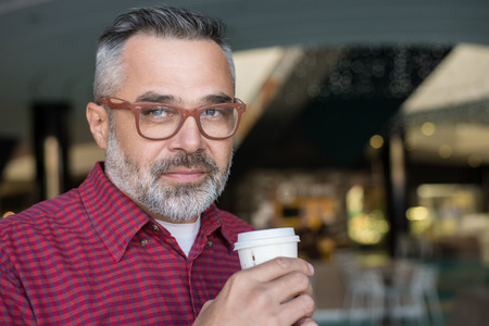 Stylish adult man drinking coffee