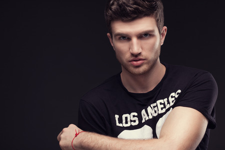 Stylish guy close up portrait on black backgroundの写真素材