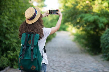 Traveler using smartphone camera to take selfie or shooting streetの写真素材