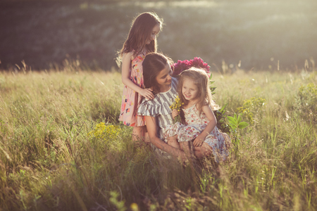 family portrait of mother with two daughters during nature strollの写真素材