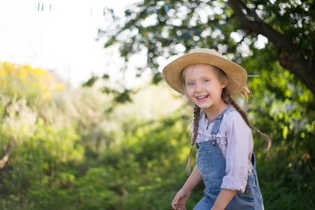 Happy face of little helper girl during fall gardeningの写真素材