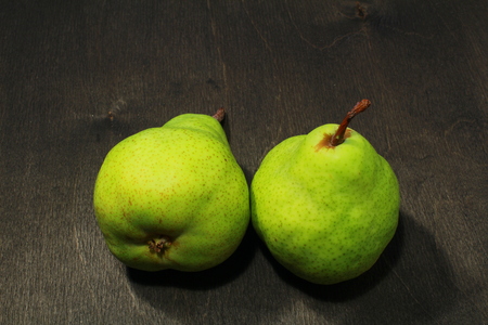 fresh green pears in black wooden backgroundの写真素材