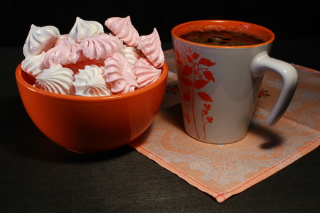 Meringue Cookies with nuts and cup of coffee on dark wooden background, top viewの写真素材
