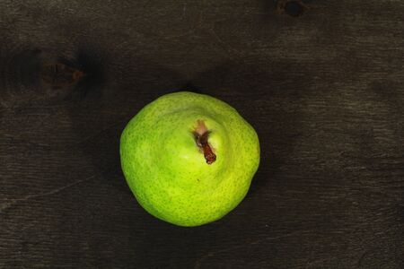fresh green pears in black wooden backgroundの写真素材