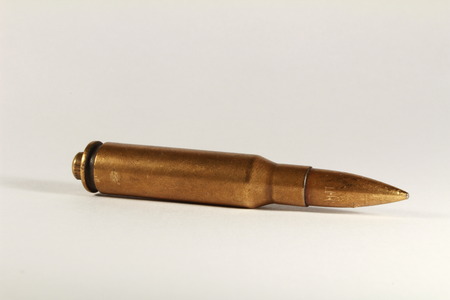medium caliber automatic rifle ammo on white background