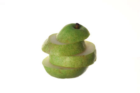 organic green pear in slices on white backgroundの写真素材