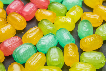 Mixed colorful fruit hard candies as backgroundの写真素材