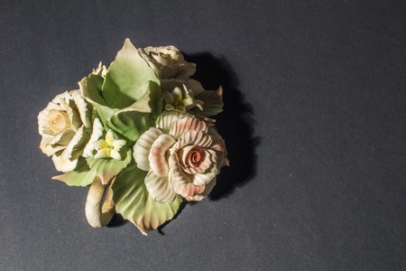 green ceramic candlestick rose on black backgroundの写真素材