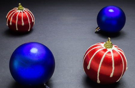blue and red christmas balls on black backgroundの写真素材