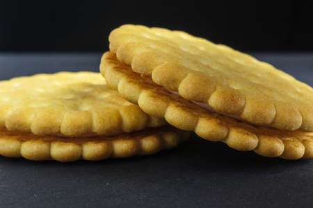 Vanilla sweet cream cookies on black backgroundの写真素材