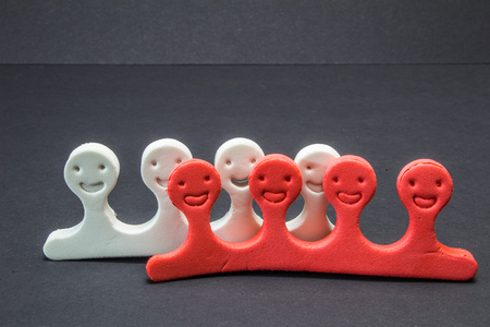 miniature faces of human, white and red, pedicure tool