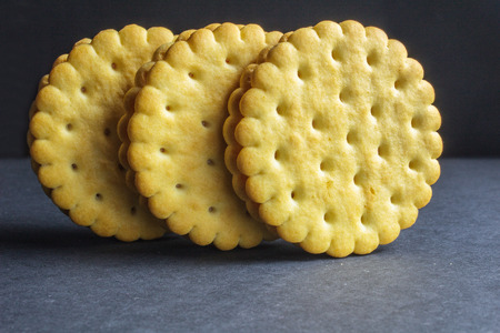Vanilla sweet cream cookies on black backgroundの写真素材