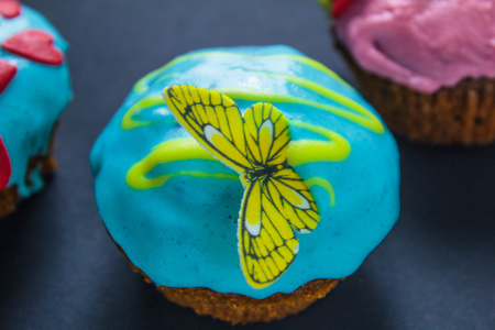 Cupcakes with sweet color cream on black backgroundの写真素材