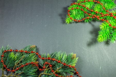 Christmas border design on the dark background.Spruce branches, beadsの写真素材