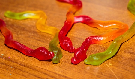 Colorful Jelly Worms Snakes on wooden backgroundの写真素材
