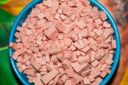 sausage slices on blue plateの写真素材