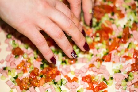 roll cooking sliced cucumber, sausage, tomato on pita, blur backgroundの写真素材