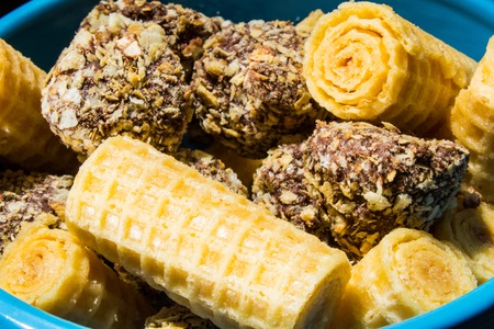 Plate with assorted group of sweets, cookies and confectioneries on black