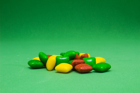 colorful chewing gum on green background
