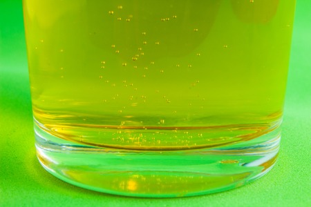 cold glass of beer on green backgroundの写真素材