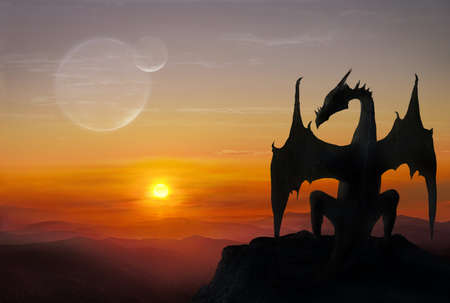 Black dragon is sitting on a stone against setting sunの写真素材