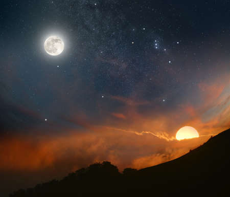 Abstract picture of the night sky opposite the rising sunの写真素材