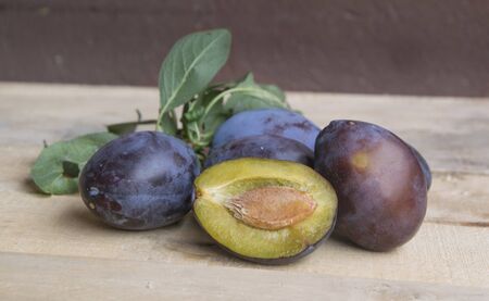 fresh plums on old wooden background. selective focusの写真素材