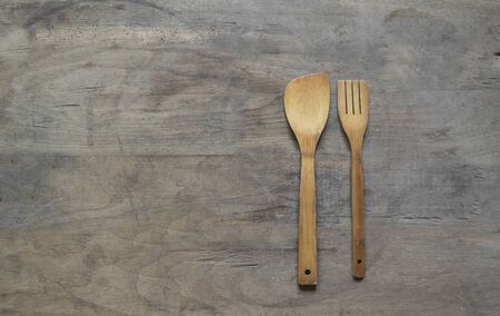 Wooden cutlery on old , wooden, rusty background.