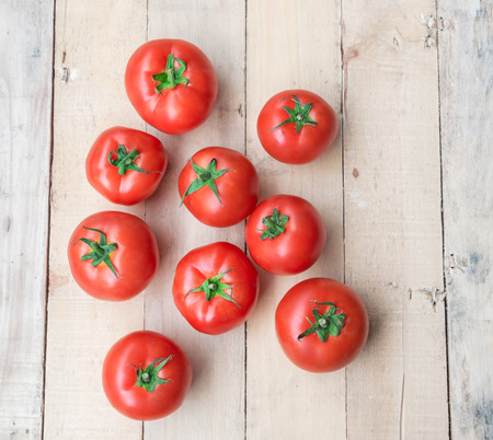 Fresh cherry tomatoes on rustic wooden backgroundの写真素材