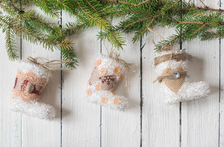 Beautiful christmas decoration (baubles, lights, pine branches) on old white, wooden background....
