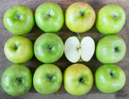 Large group of healthy, green apples on wooden table.の写真素材