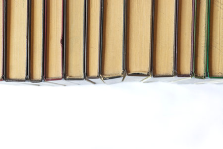 Old books with yellow pages isolated on white background, high angle view with space for textの写真素材