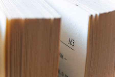 Macro image of yellow images of old, big book turned on page 165の写真素材