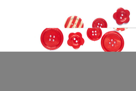 Various red sewing buttons isolated on background with place for textの写真素材
