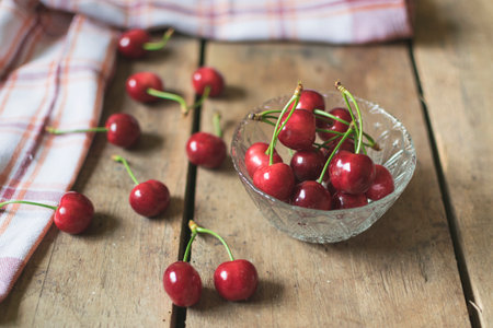 Fresh cherries on old, rustic wooden background.の写真素材
