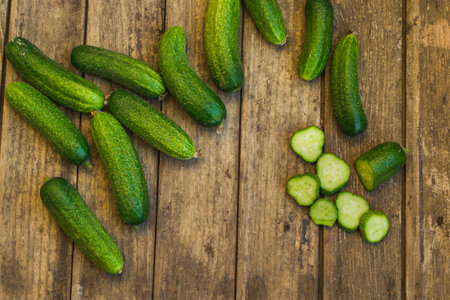 Fresh cucumbers on old wooden table. Top viewの写真素材