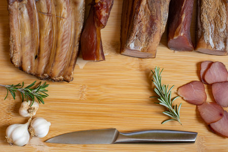 Dried pork meat on wooden table with place for textの写真素材