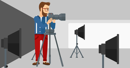 A photographer working with camera on the background of photo studio with lighting equipment vector flat design illustration. Horizontal layout.のイラスト素材