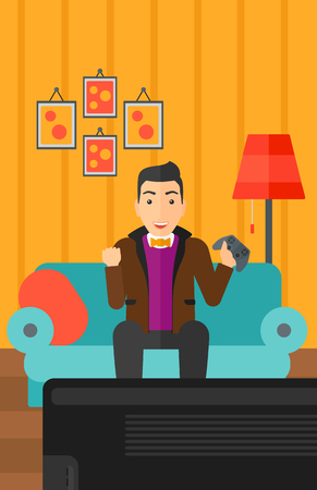 A happy man with gamepad in hands sitting on a sofa in living room vector flat design illustration. Vertical layout.のイラスト素材