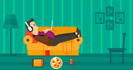 A fat man in headphones lying on a sofa in living room with electronic devices and fast food vector flat design illustration. Horizontal layout.のイラスト素材