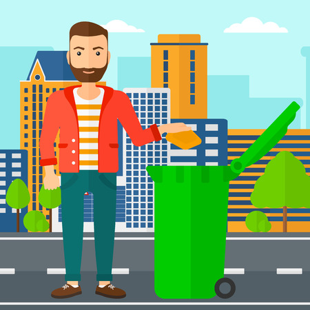 A hipster man with the beard throwing a trash into a green bin on a city background vector flat design illustration. Square layout.のイラスト素材