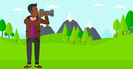 An african-american man taking photo on the background of green forest and mountains vector flat design illustration. Horizontal layout.のイラスト素材