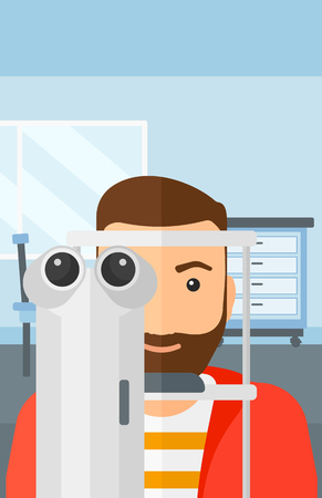 A hipster man with the beard during eye exam on the background of medical office vector flat design illustration. Vertical layout.のイラスト素材