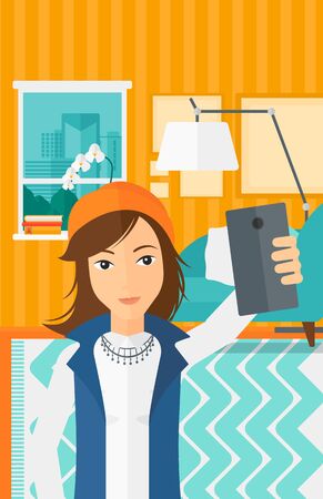 A woman making selfie on the background of living room vector flat design illustration. Vertical layout.のイラスト素材