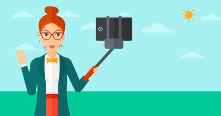 A woman making selfie with a selfie-stick on the background of blue sky vector flat design illustration. Horizontal layout.のイラスト素材